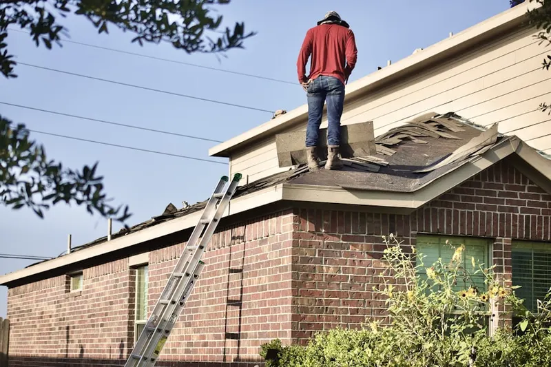 Professional roofer working on a residential roof in Edinburg